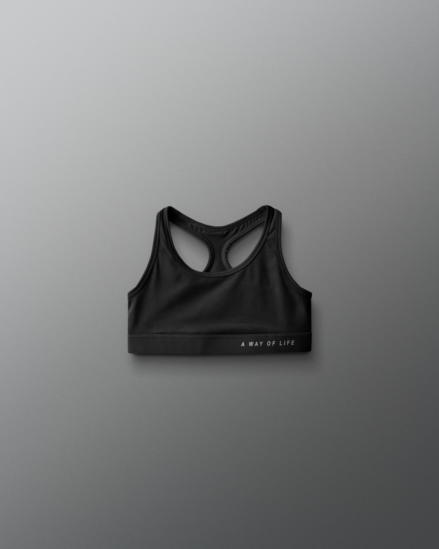 Black sports bra on a gray background