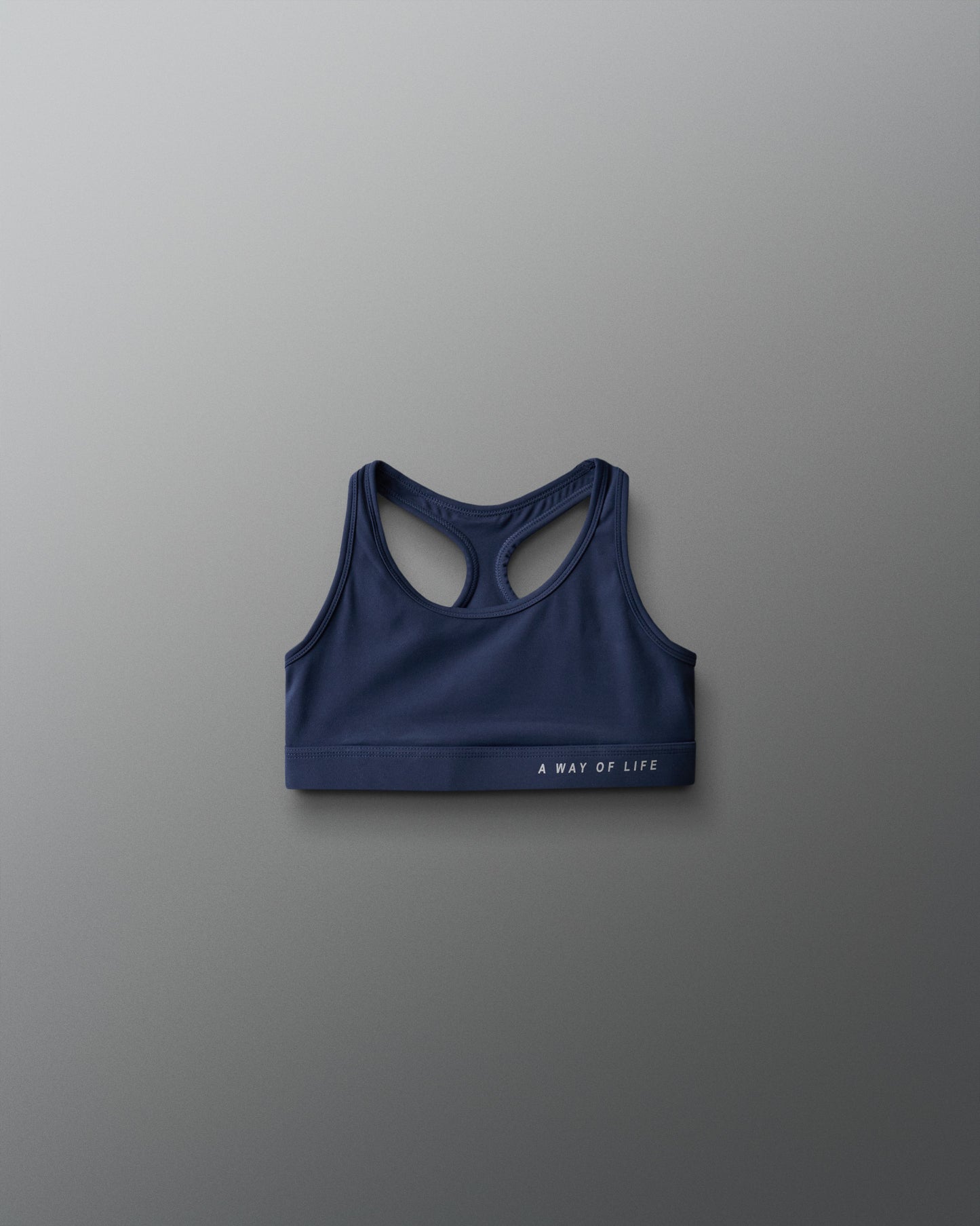Blue sports bra with 'A Way of Life' text on a gray background