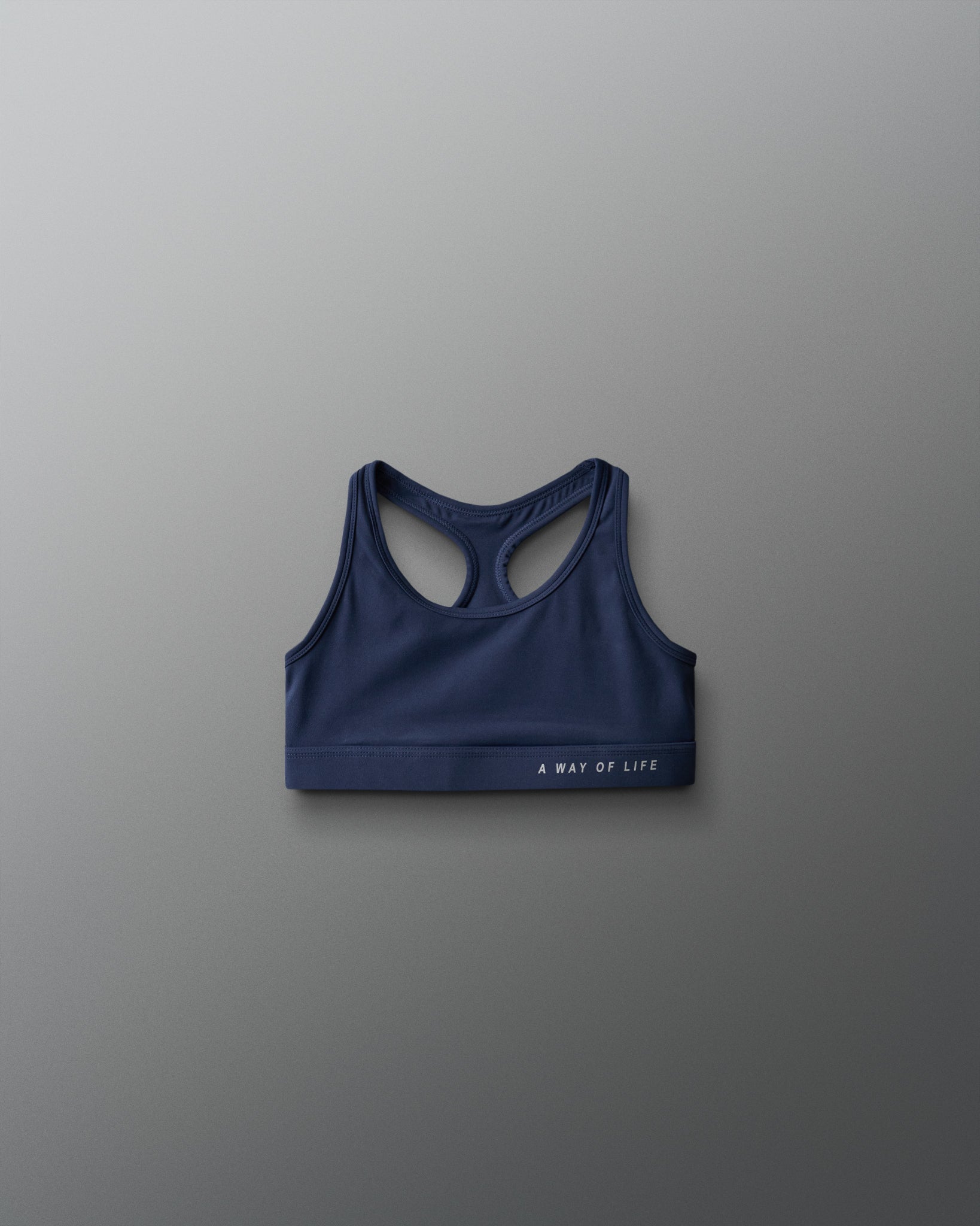 Blue sports bra with 'A Way of Life' text on a gray background
