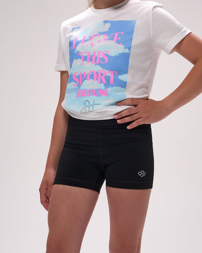 Person wearing a white t-shirt with a colorful graphic and black shorts on a light gray background