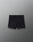 Black athletic shorts with a logo on a gray background