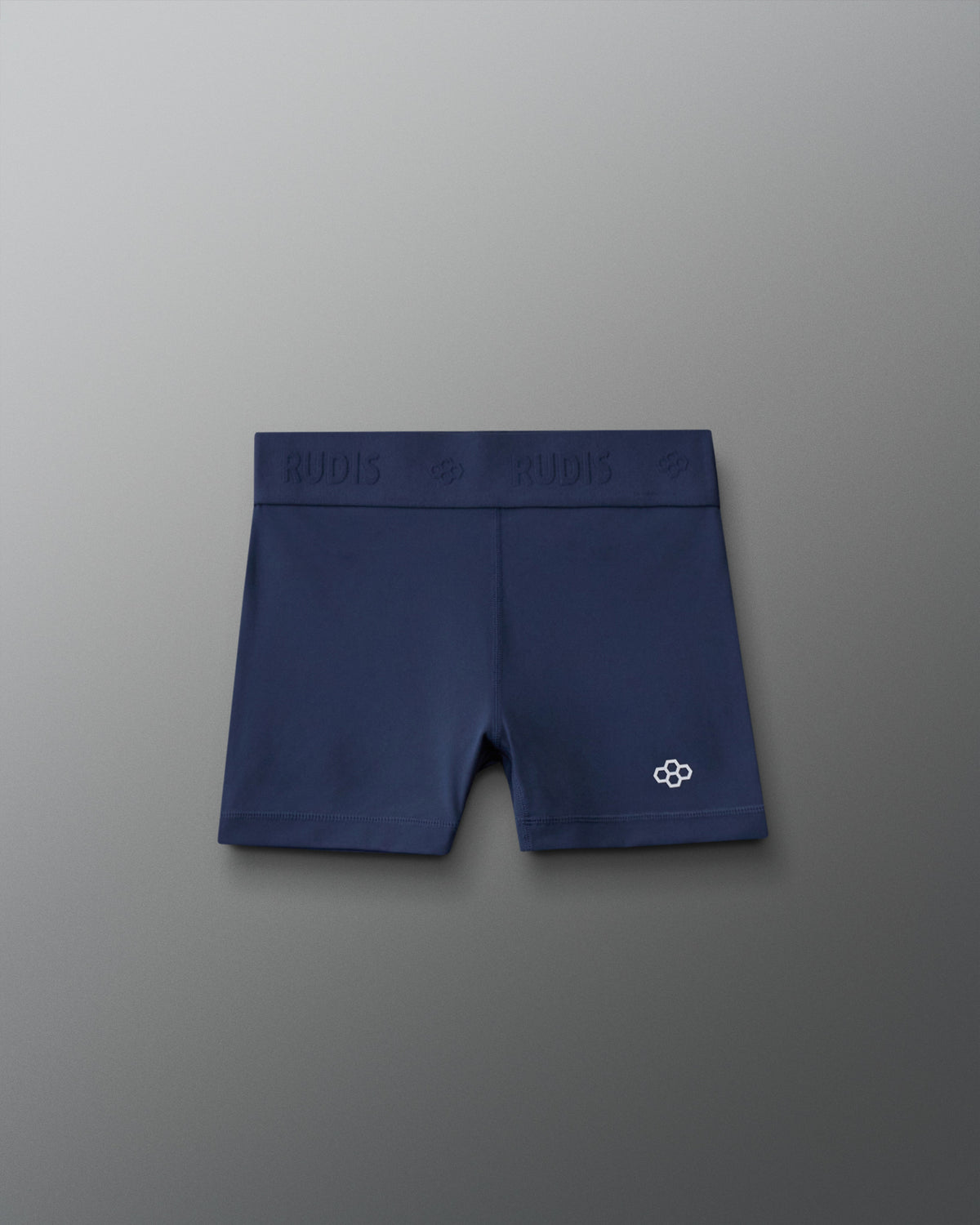 Front view of the RUDIS Girls Compression Short in Navy, featuring a wide RUDIS-branded waistband, fitted compression silhouette and white RUDIS emblem on the left leg.