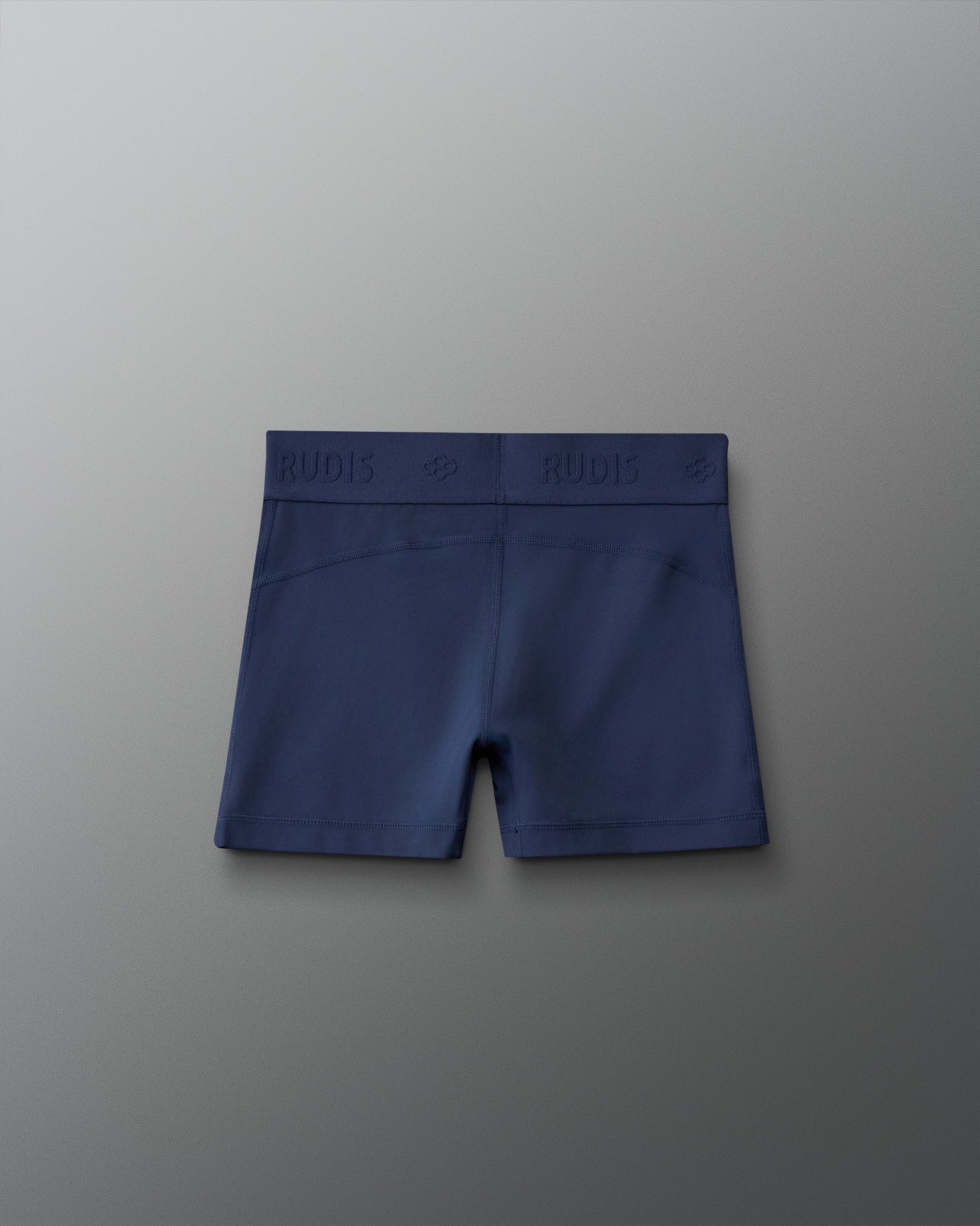 Back view of the RUDIS Girls Compression Short in Navy, highlighting the tonal RUDIS logo waistband, contoured rear stitching and fitted compression design.