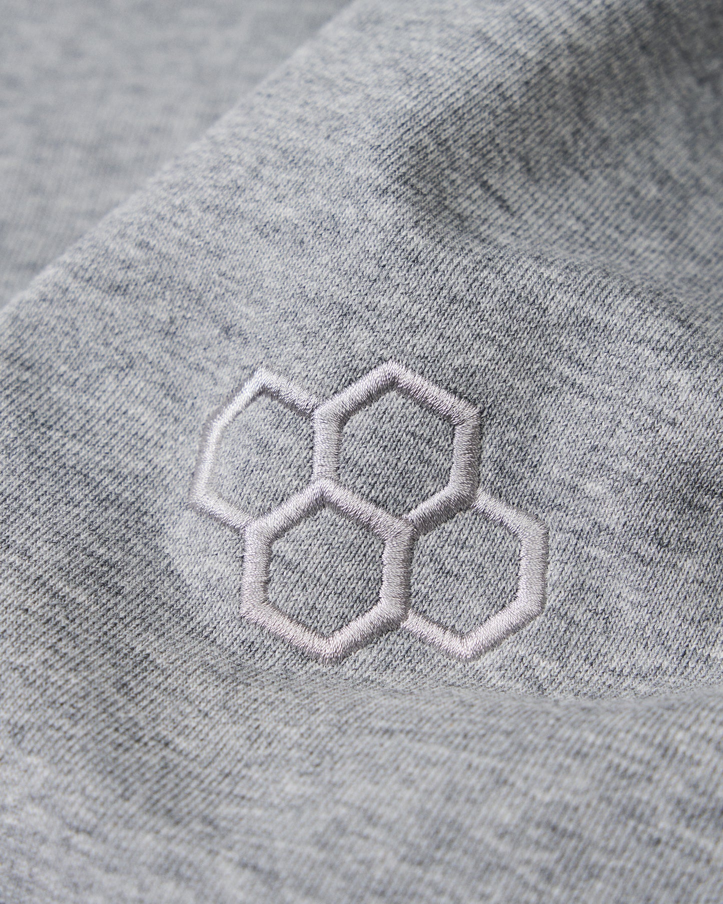 Gray fabric with embroidered hexagonal pattern