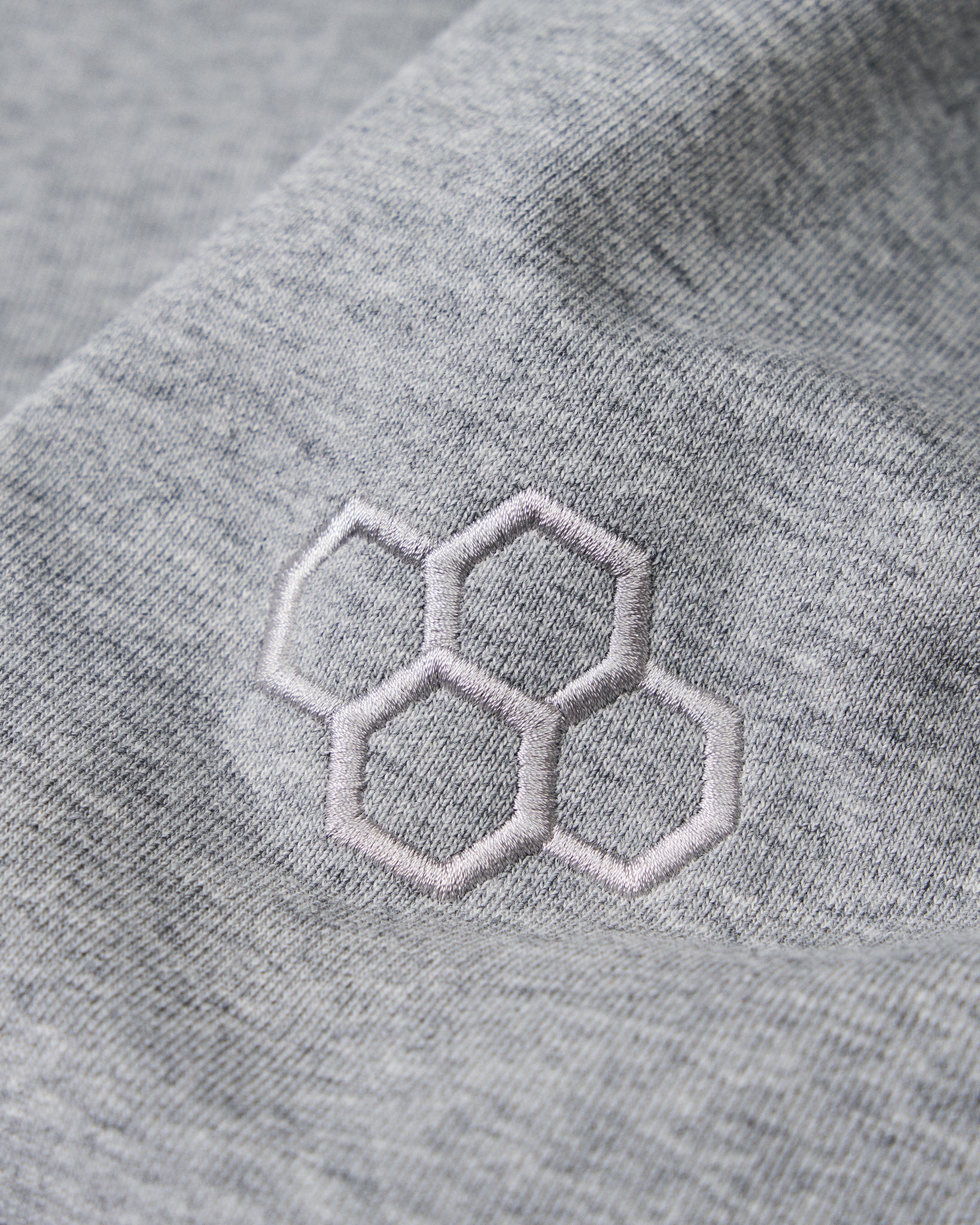 Gray fabric with embroidered hexagonal pattern