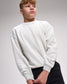Person wearing a light gray sweatshirt on a plain background