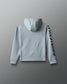 Gray hoodie with a brand logo on the sleeve against a gray background