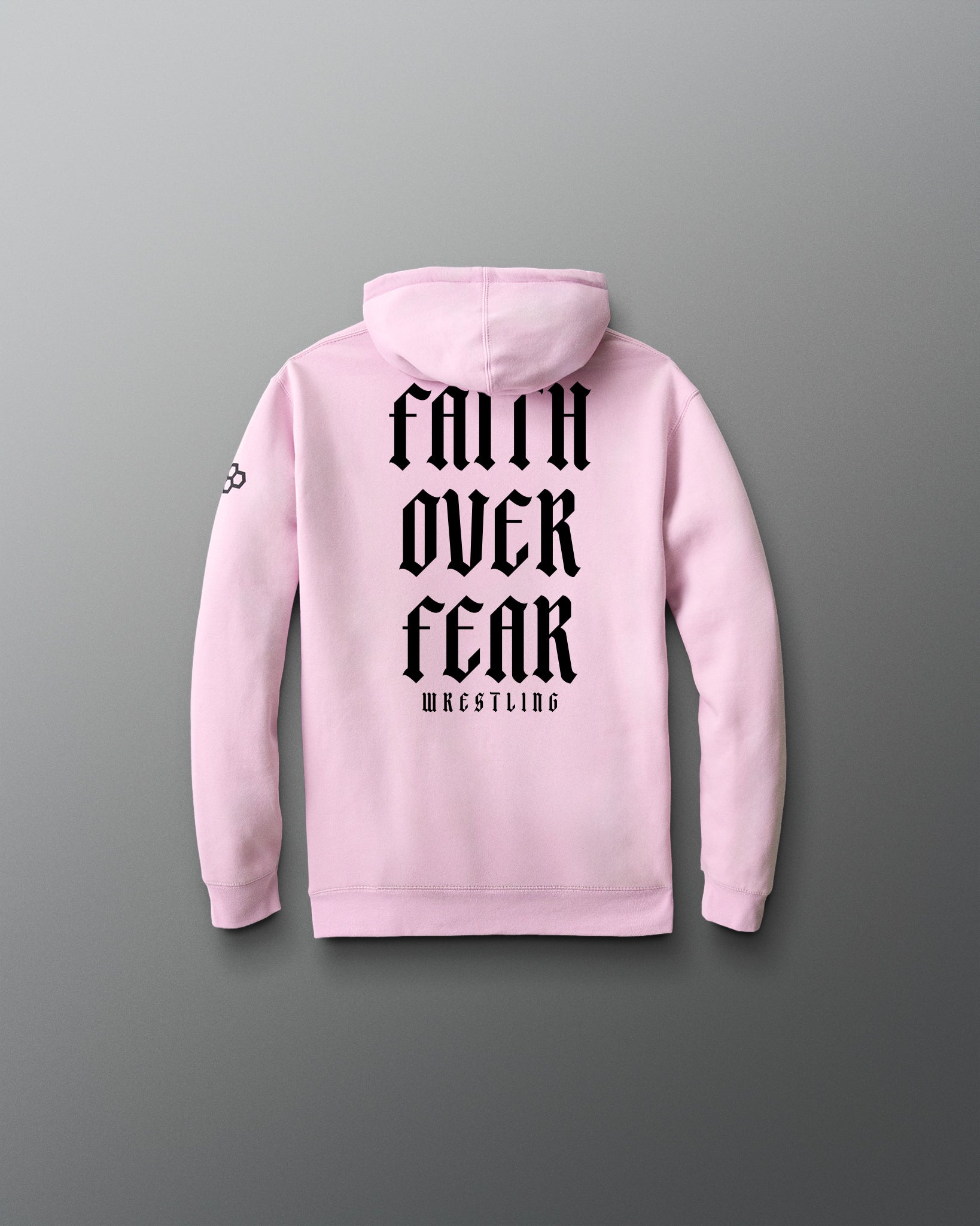 Pink hoodie with 'Faith Over Fear Wrestling' text on the back against a gray background