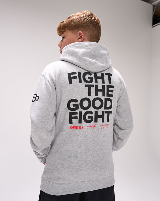 Person wearing a gray hoodie with 'Fight the Good Fight' text on the back, standing against a plain background.