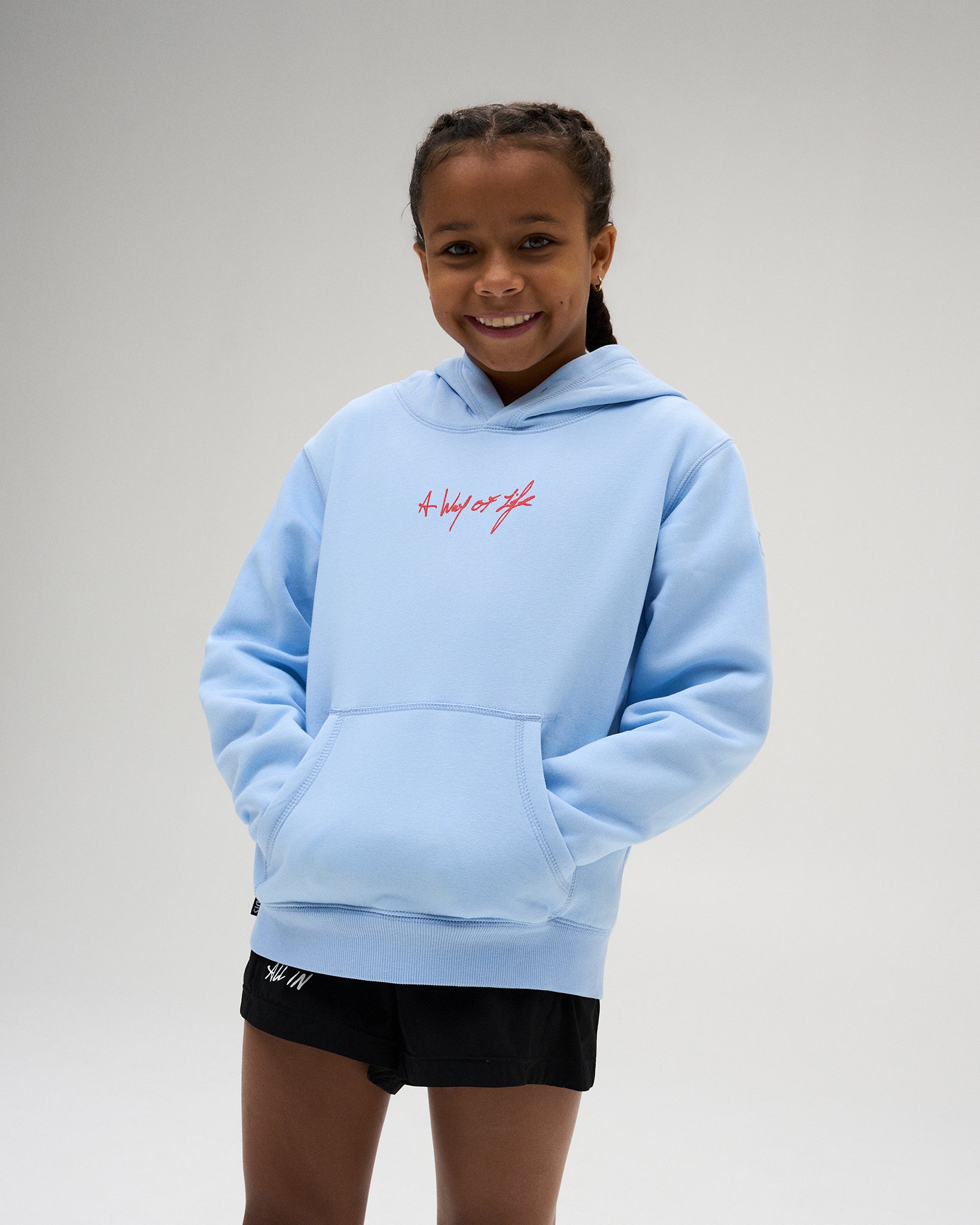 RUDIS Fear Has No Power Youth Comfort Fleece Hoodie in Light Blue, featuring a red A Way of Life chest graphic, classic hood, and front kangaroo pocket.