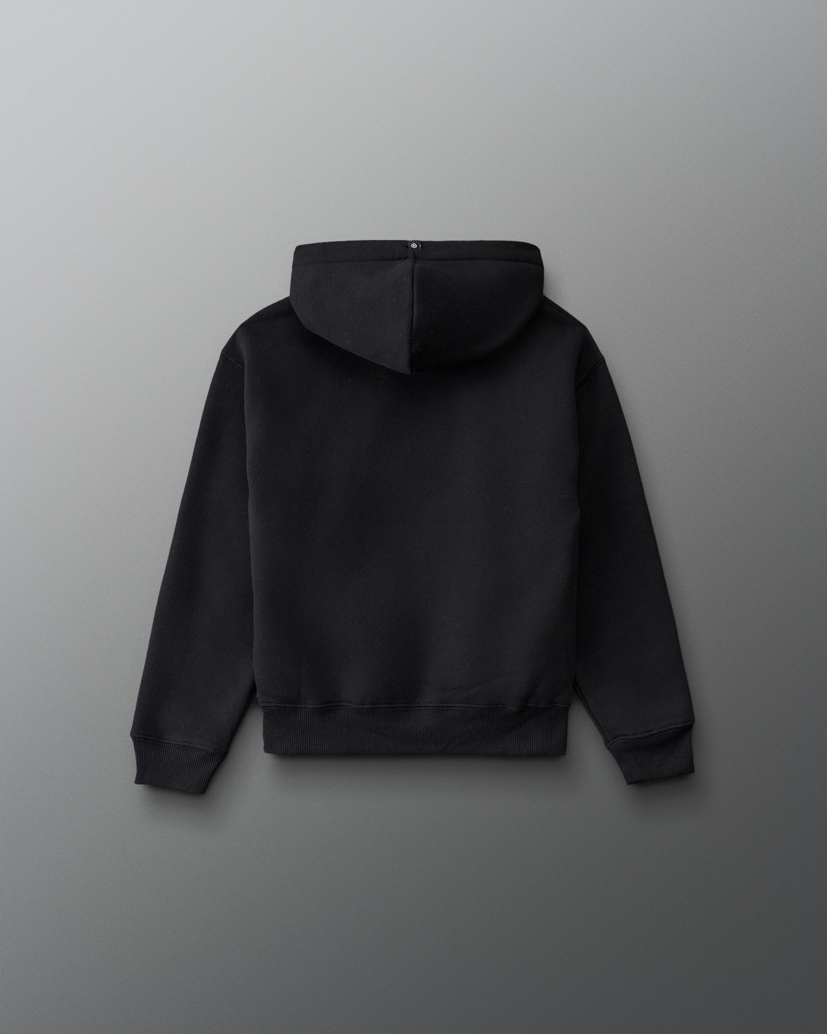 RUDIS Essential Hex Youth Relaxed Comfort Fleece Hoodie in Black, back view showing the solid black design, relaxed silhouette, hood, and ribbed hem. Copy Alt Text