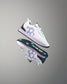 White sneakers with purple accents and black soles on a gray background
