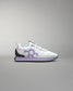 White and purple sneaker on a gray background
