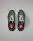 Green running shoes with white laces on a gray background