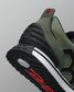 Close-up of a green and black sneaker with red accents on a gray background