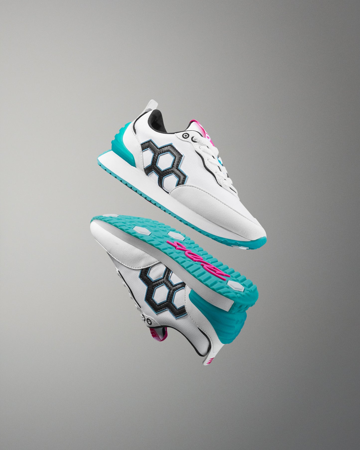 White sneakers with turquoise soles on a gray background