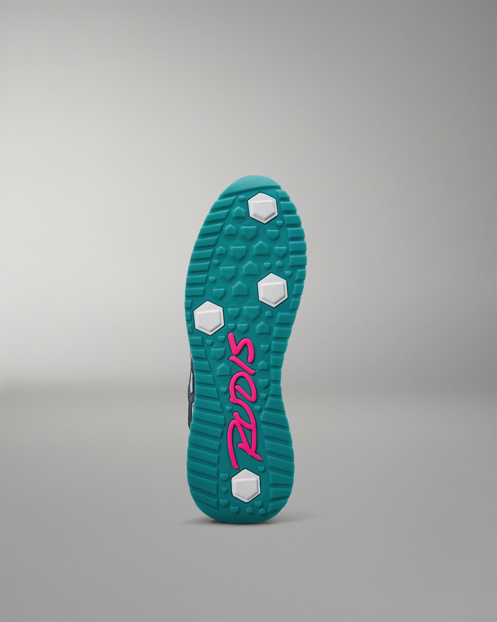 Teal shoe sole with pink logo on a gray background