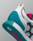 Close-up of a sneaker with teal sole and pink accents on a gray background