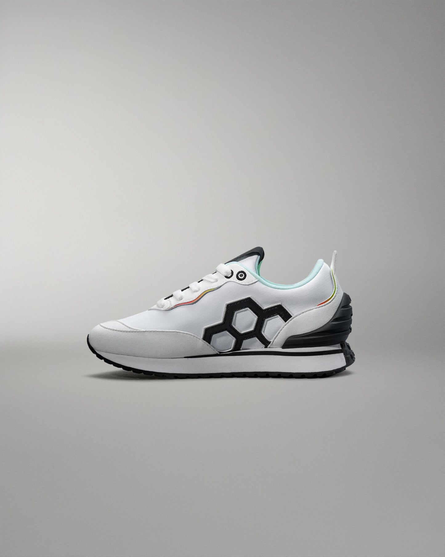 White sneaker with black geometric design on a gray background