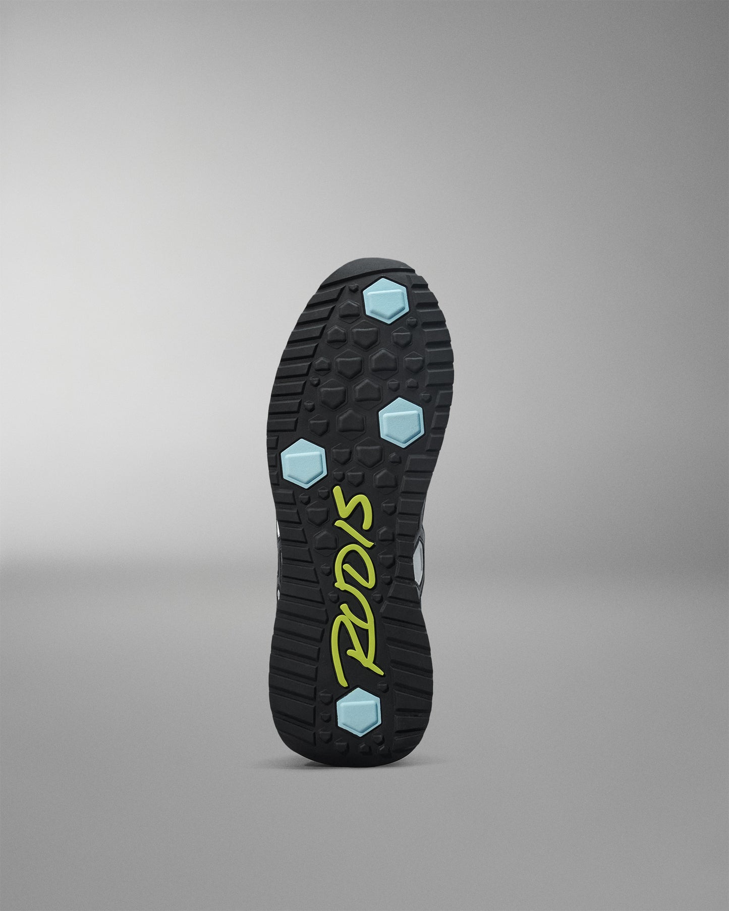 Black shoe sole with blue hexagonal patterns and 'Pryme' branding on a gray background