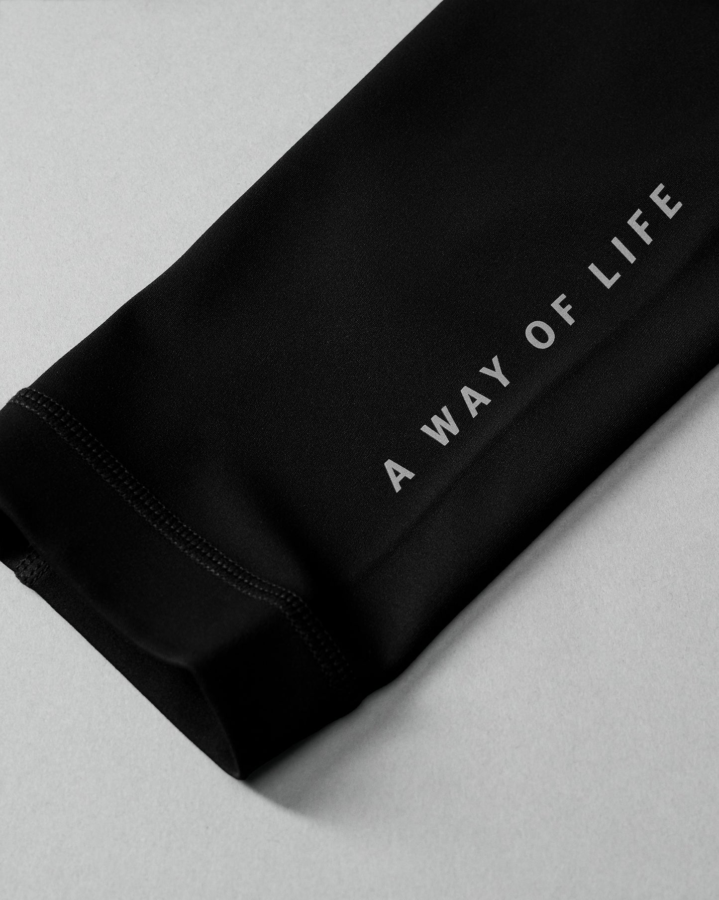 Black fabric with 'A Way of Life' text on a light gray background