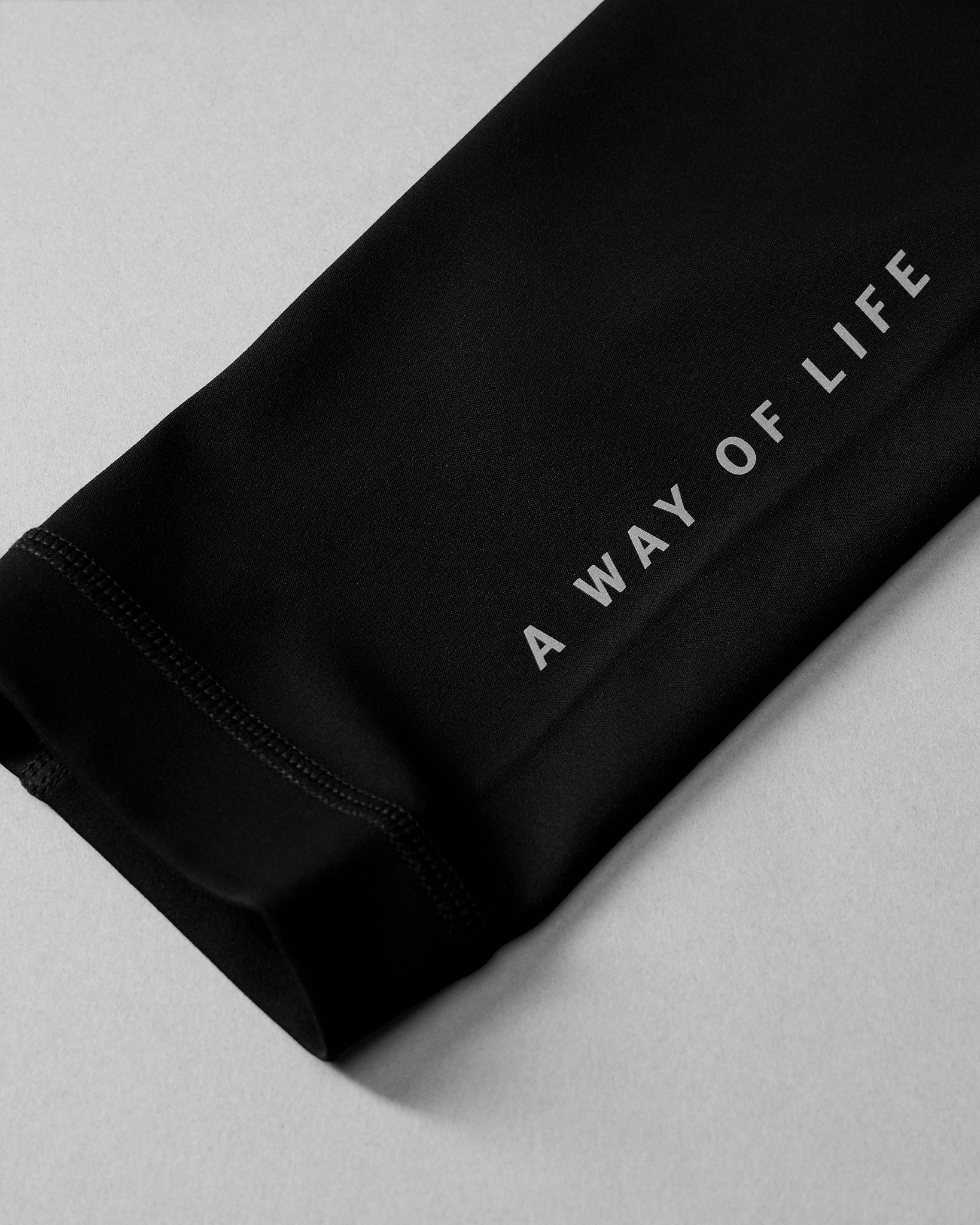 Black fabric with 'A Way of Life' text on a light gray background