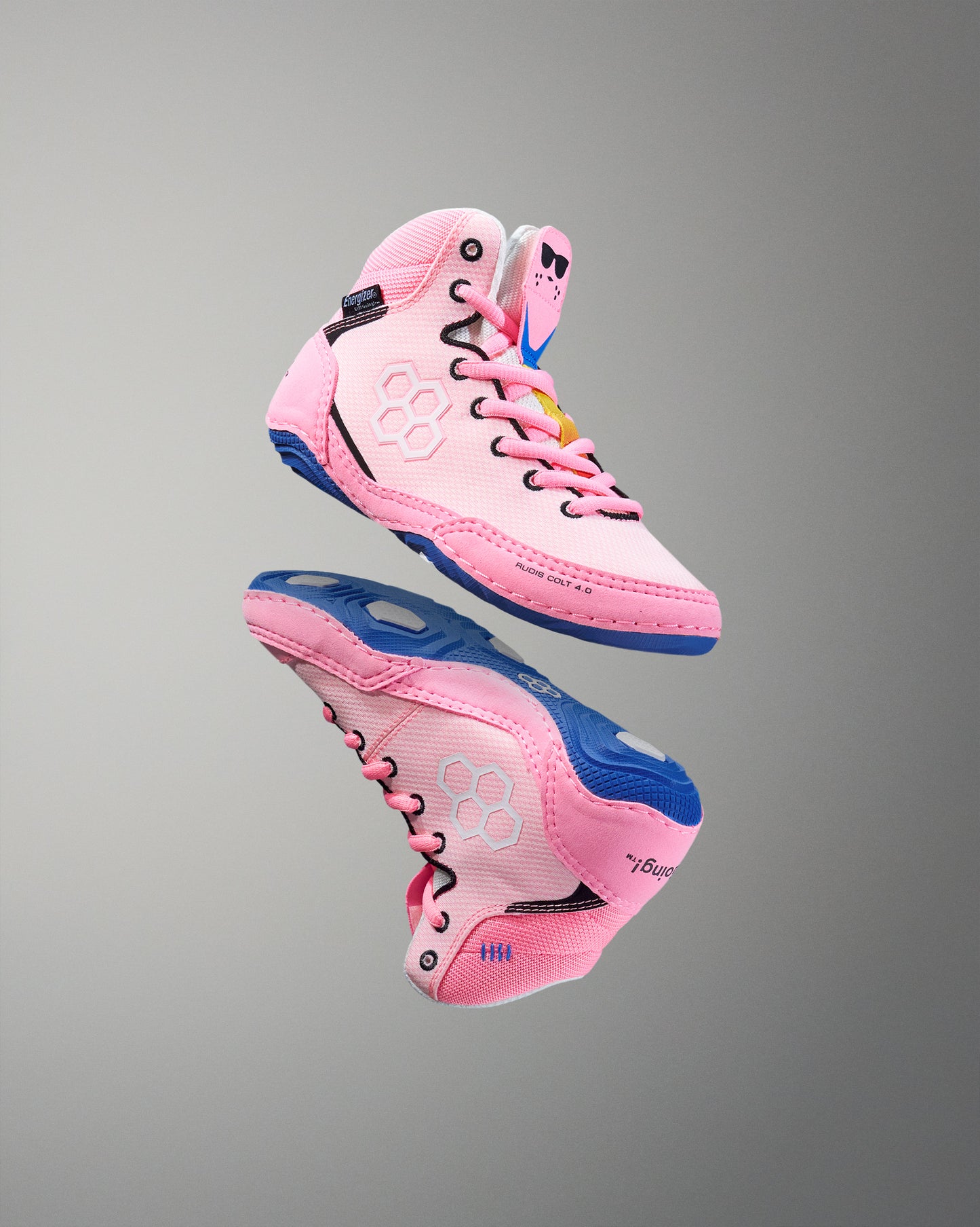 Pink and blue wrestling shoe on a gray background