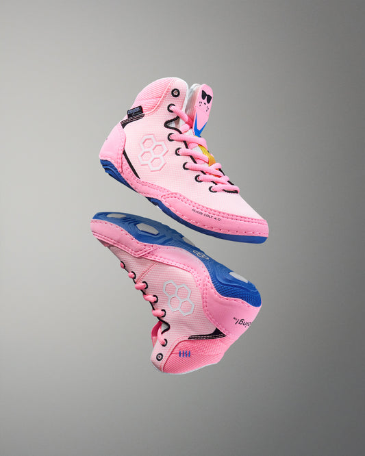 Pink and blue wrestling shoe on a gray background