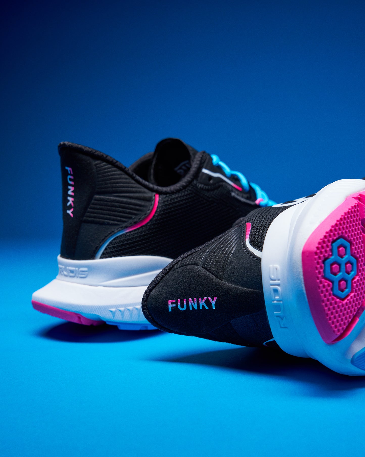 Black and pink sneakers with 'Funky' branding on a blue background