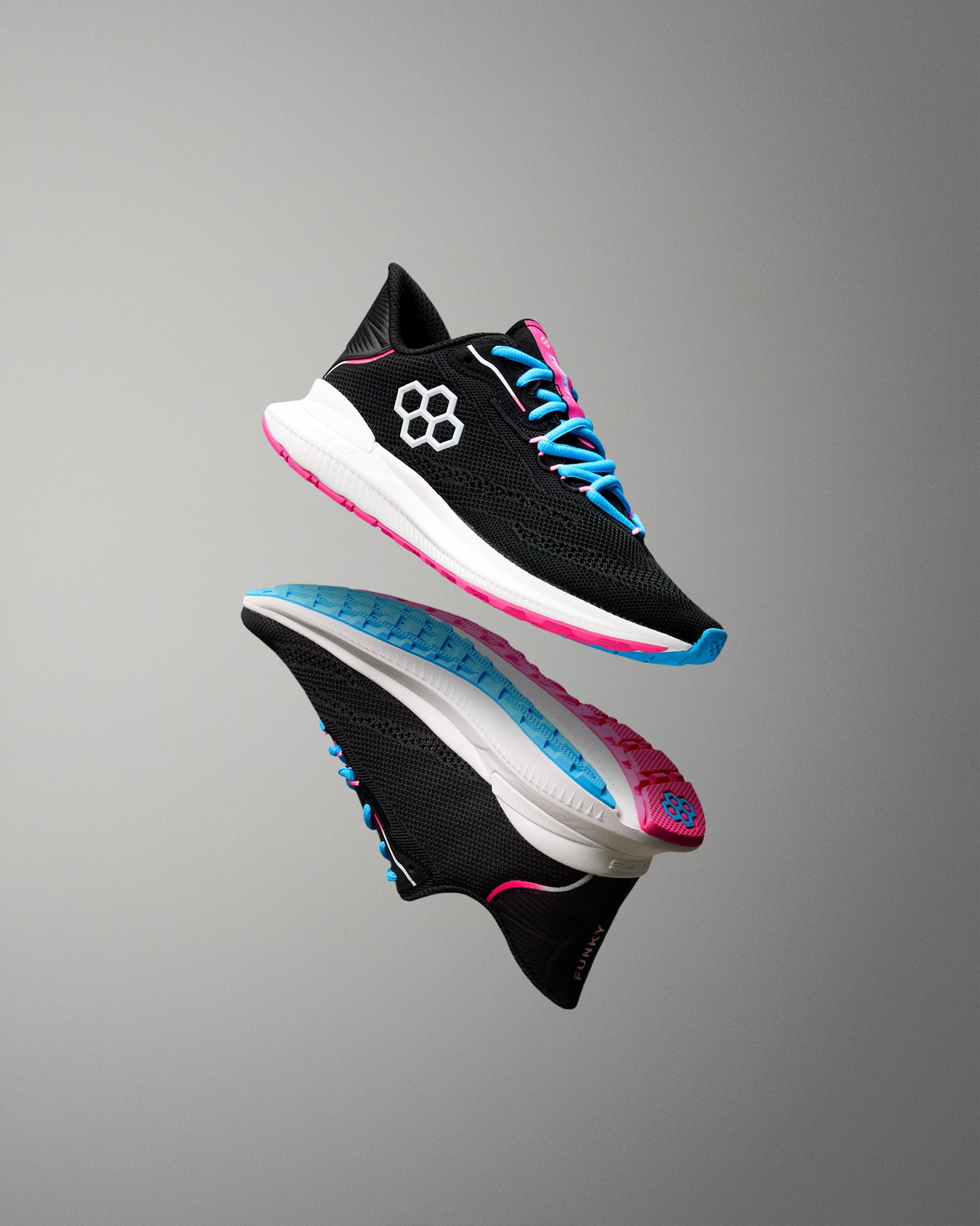 Black running shoe with blue and pink accents on a gray background
