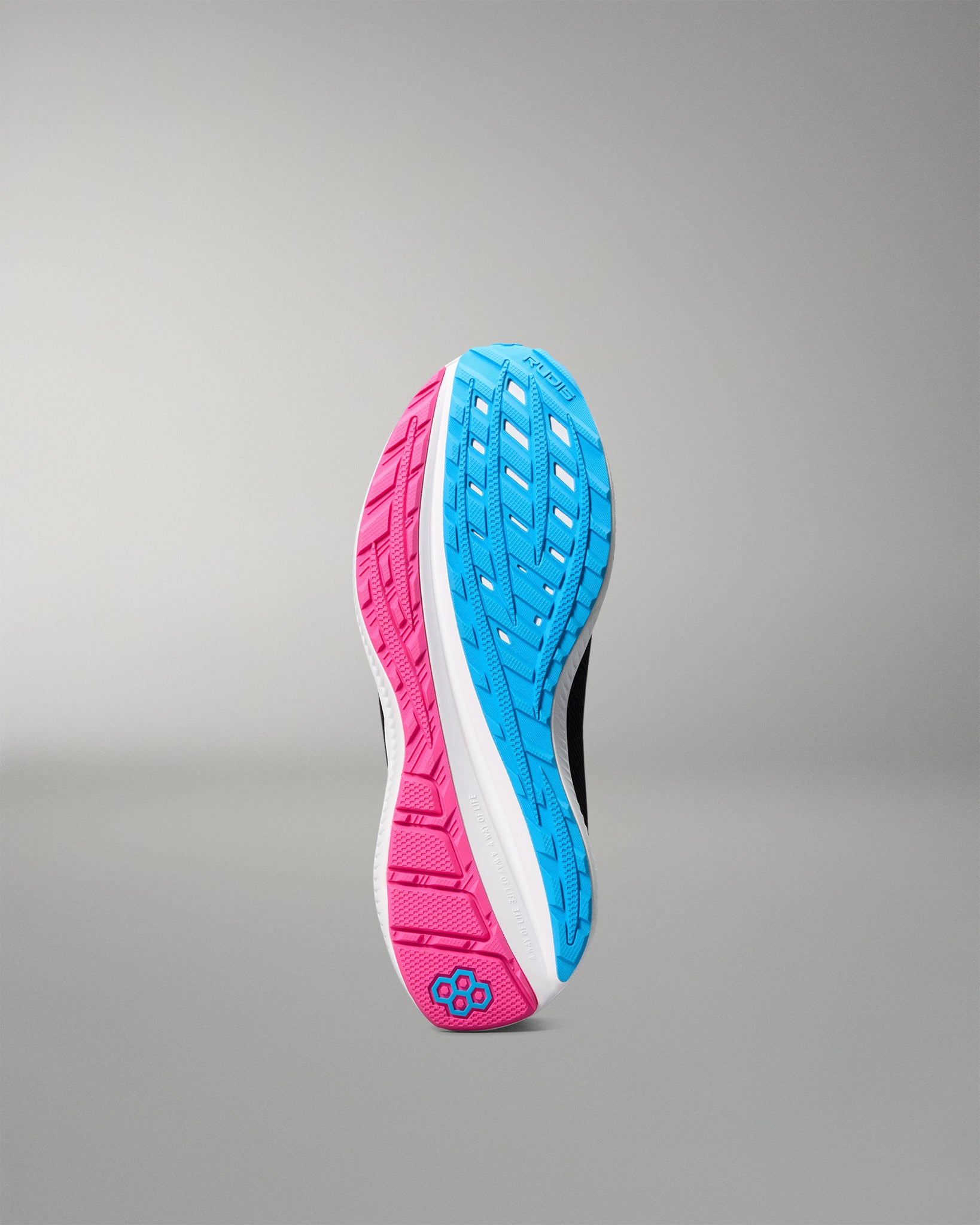 Blue and pink running shoe sole on a gray background