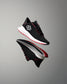Black and red athletic shoe on a gray background