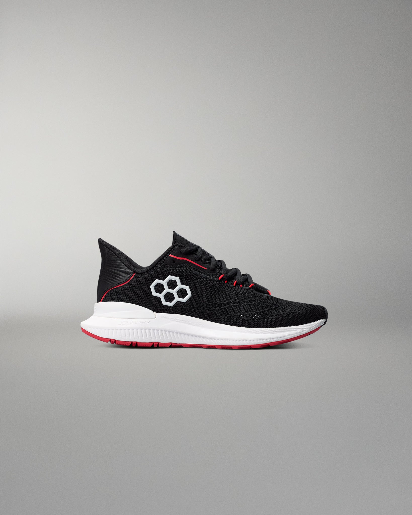 Black running shoe with white sole on a gray background