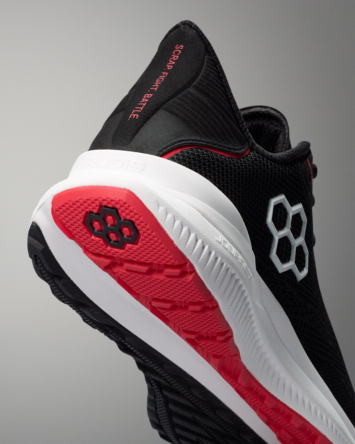 Black and red athletic shoe with visible branding on a gray background