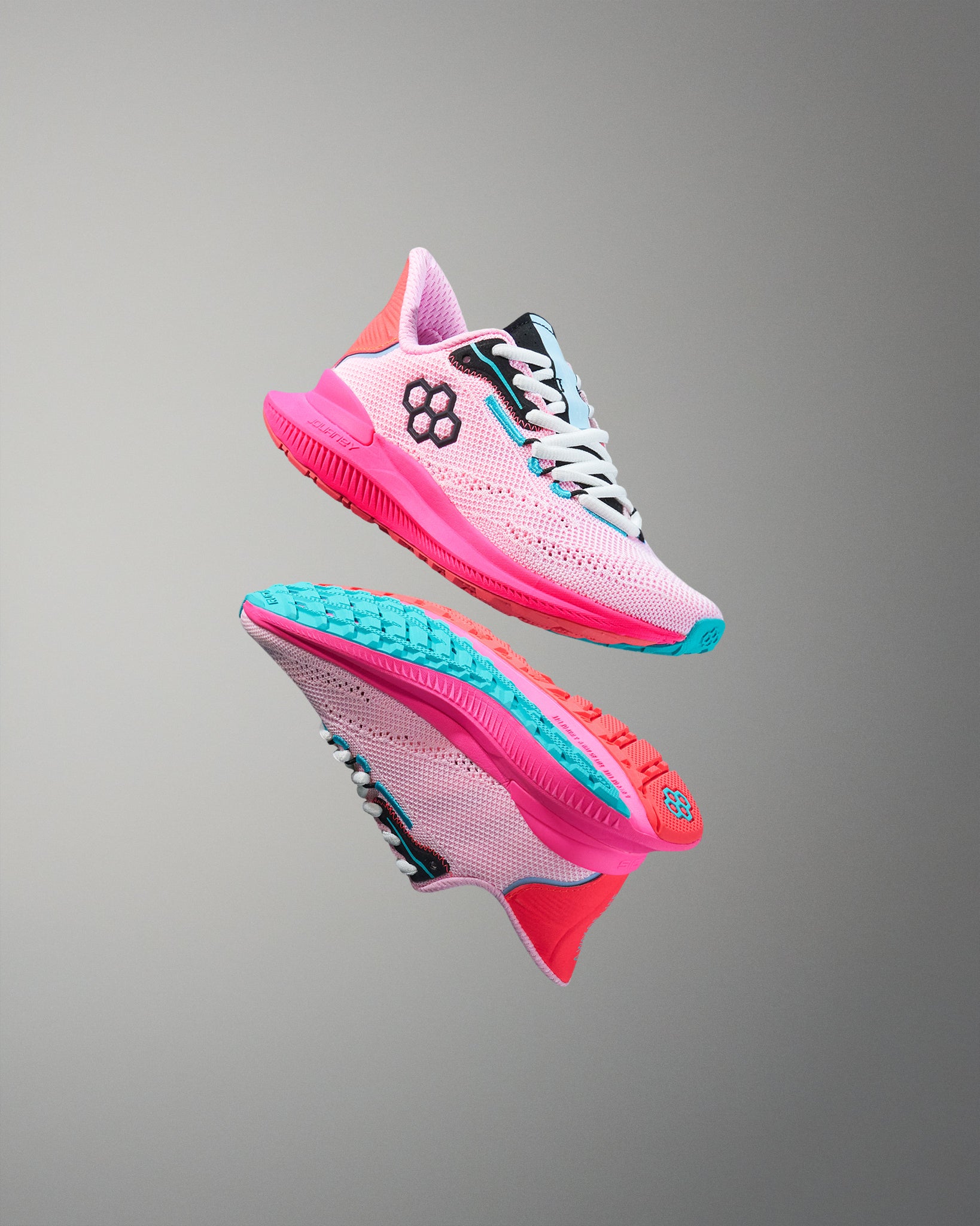 Pink and blue running shoes on a gray background