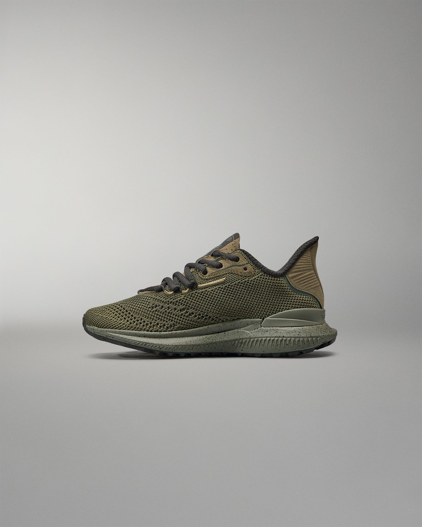 Green training shoe on a gray background