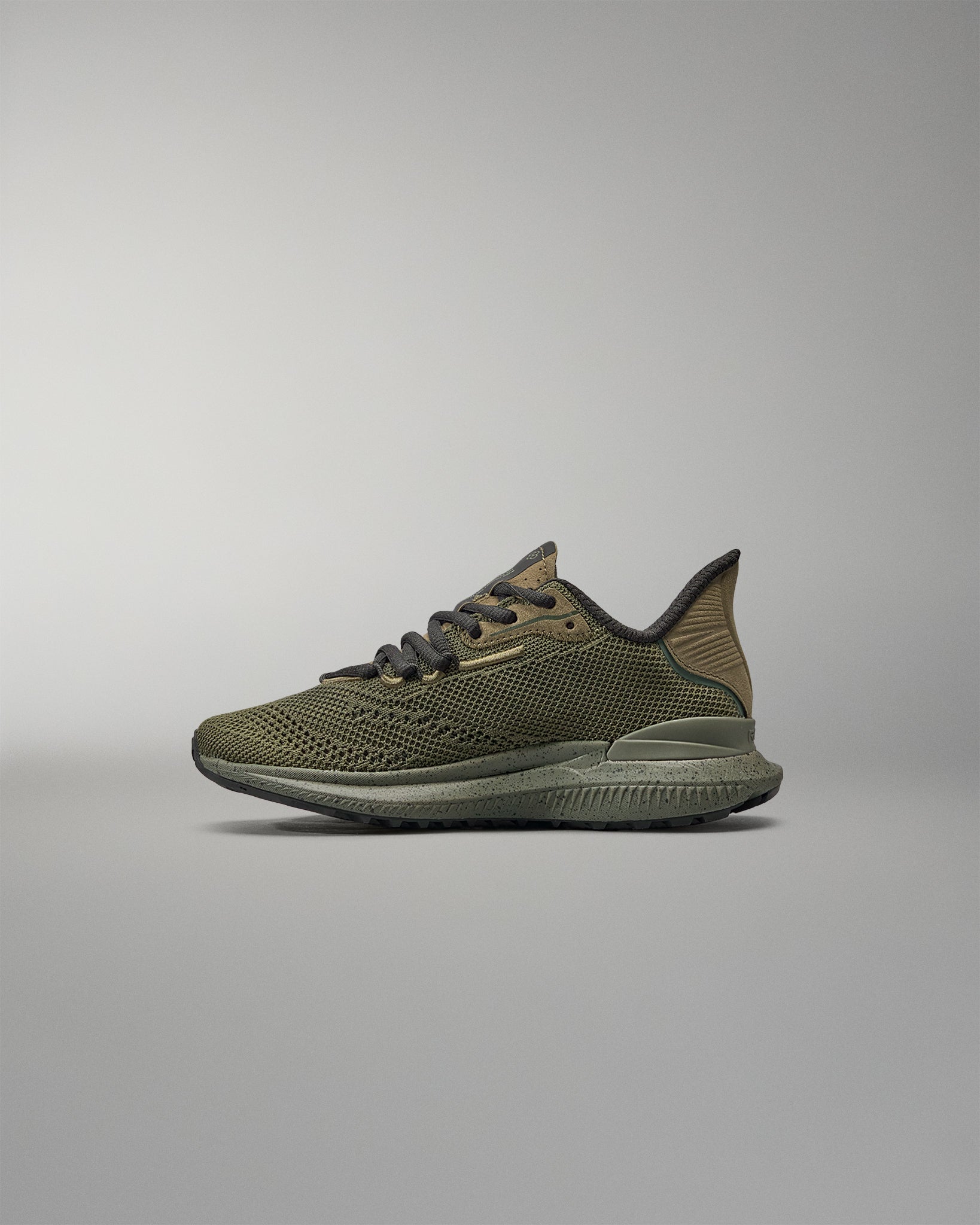 Green training shoe on a gray background