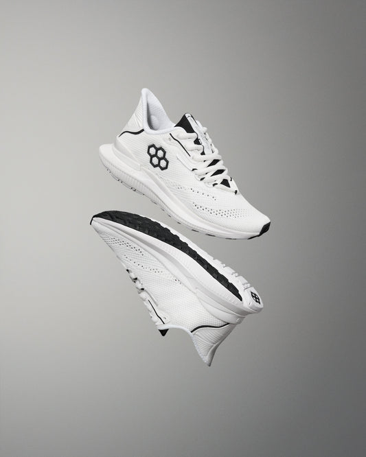 White athletic shoes with black accents on a gray background