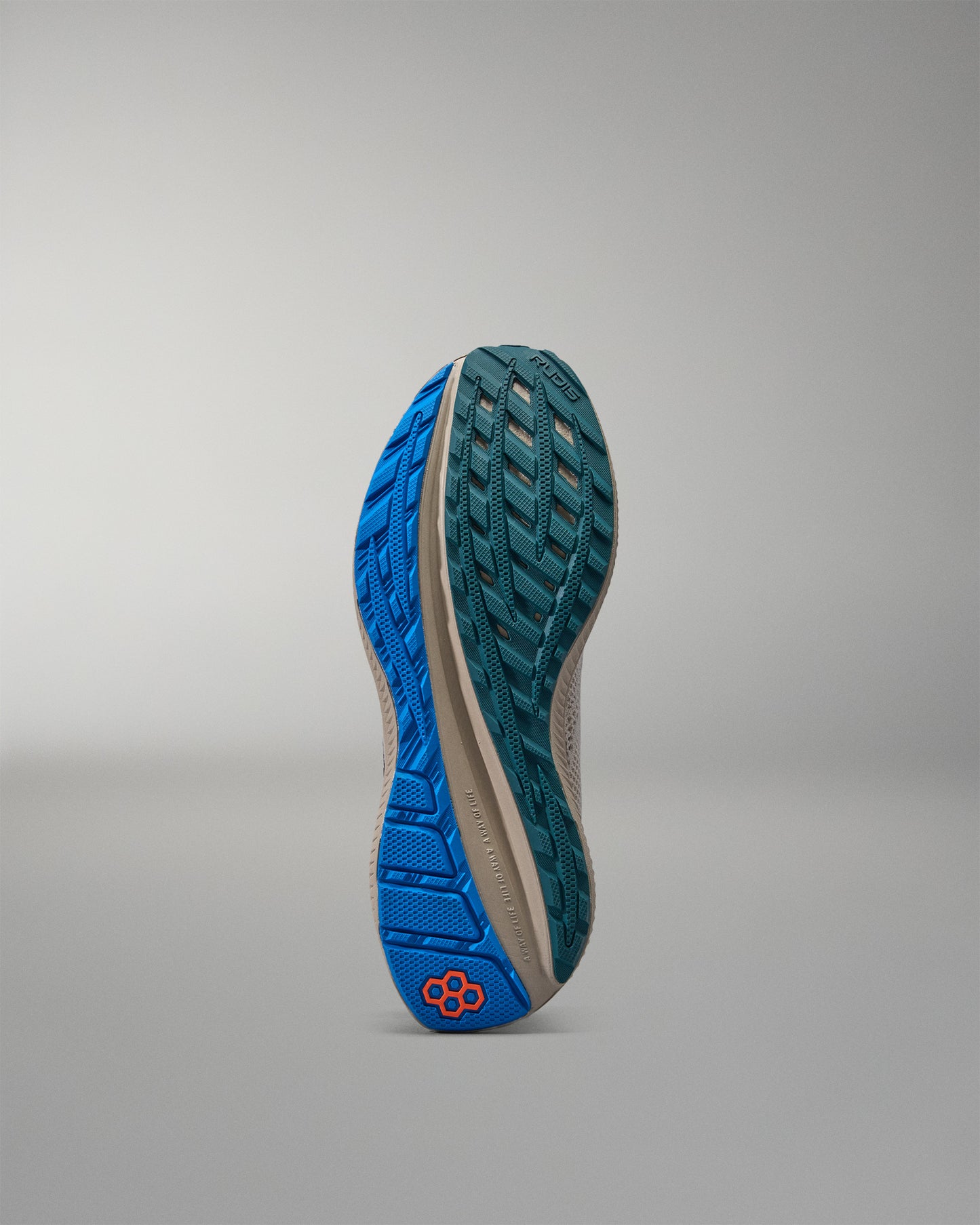 Blue and green sole of a shoe on a gray background
