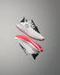 White training shoe with red soles on a gray background