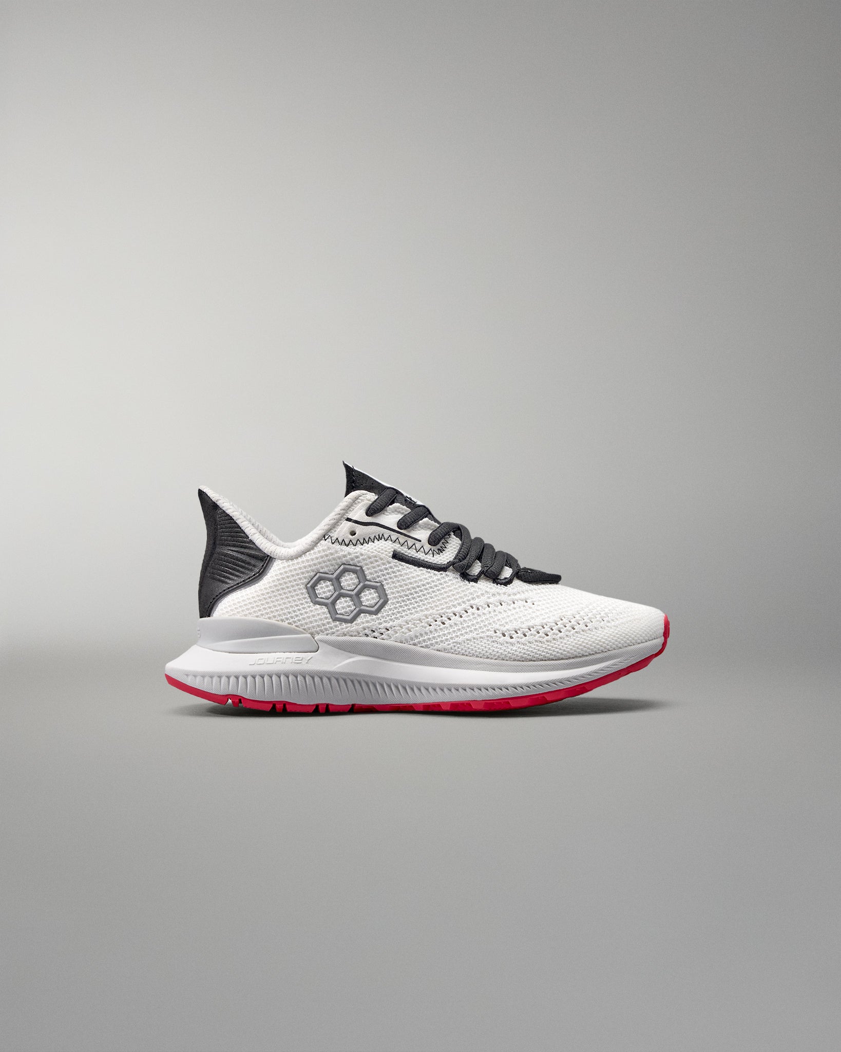 White running shoe with black and red accents on a gray background