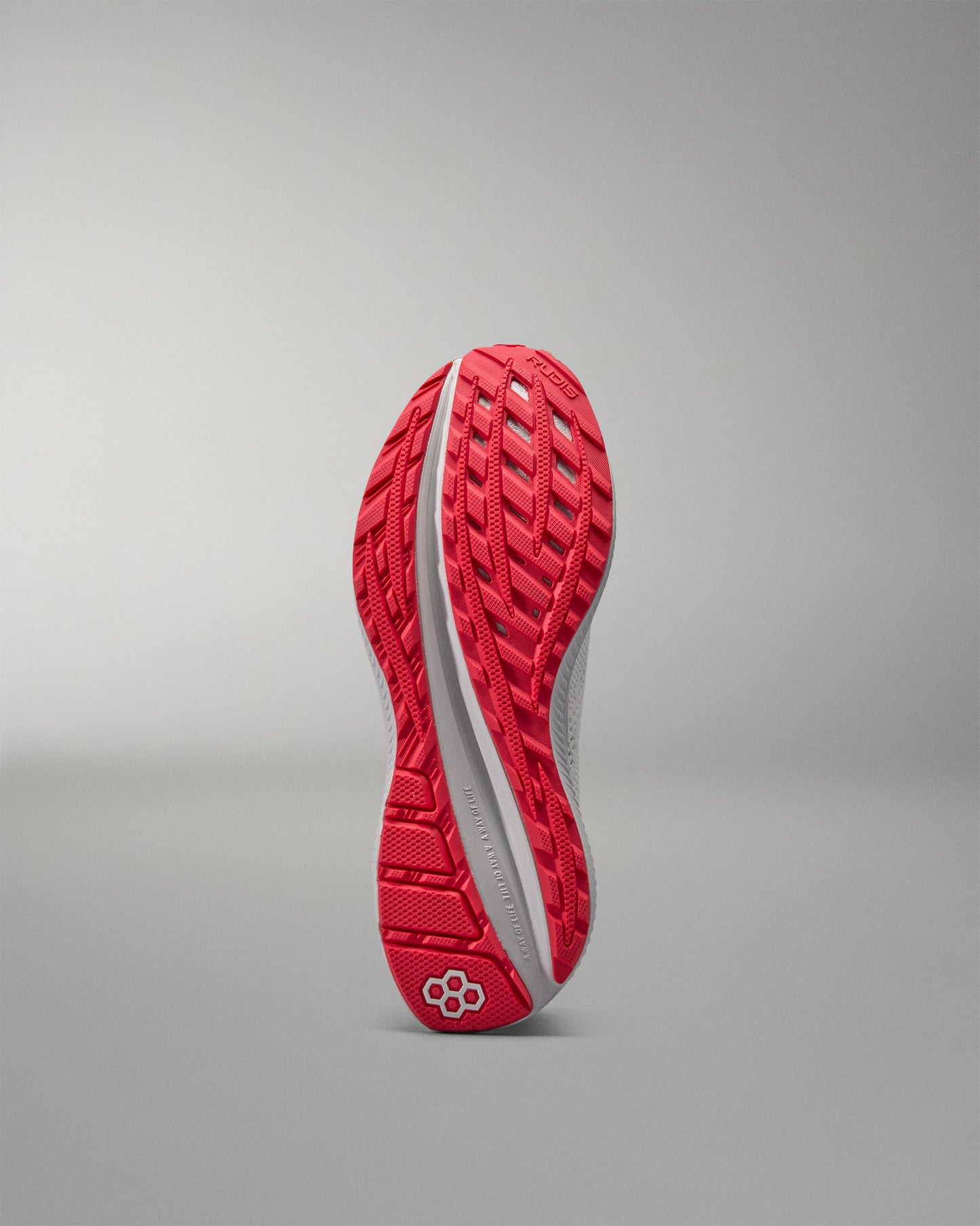 Red training shoe sole on a gray background