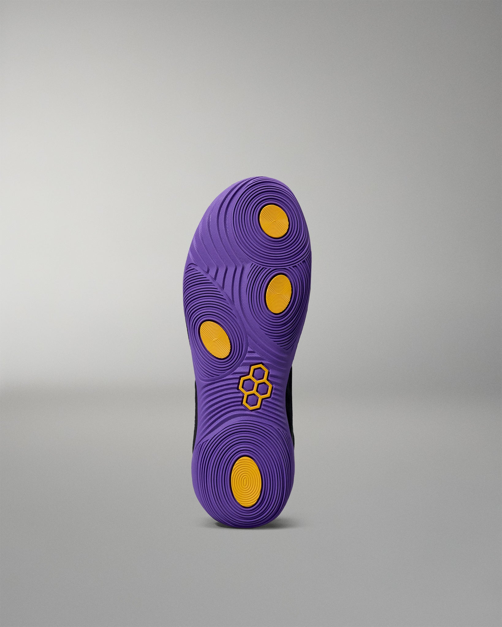 Purple shoe sole with yellow dots on a gray background