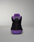 Black and purple sneaker with visible brand logo on a gray background