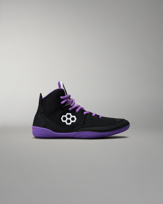 Black high-top sneaker with purple accents on a gray background