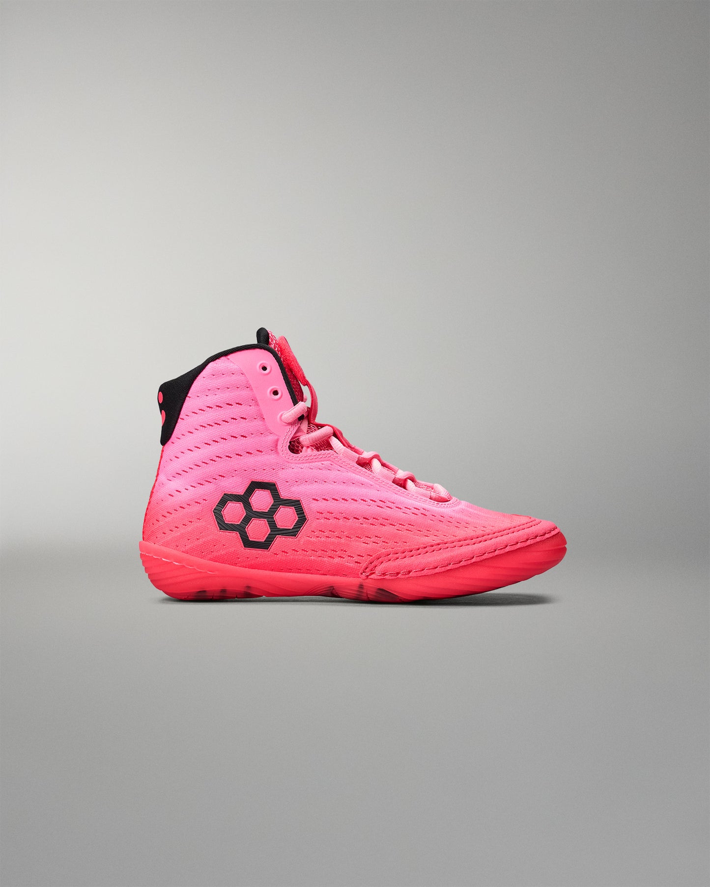 Pink wrestling shoe with black accents on a gray background
