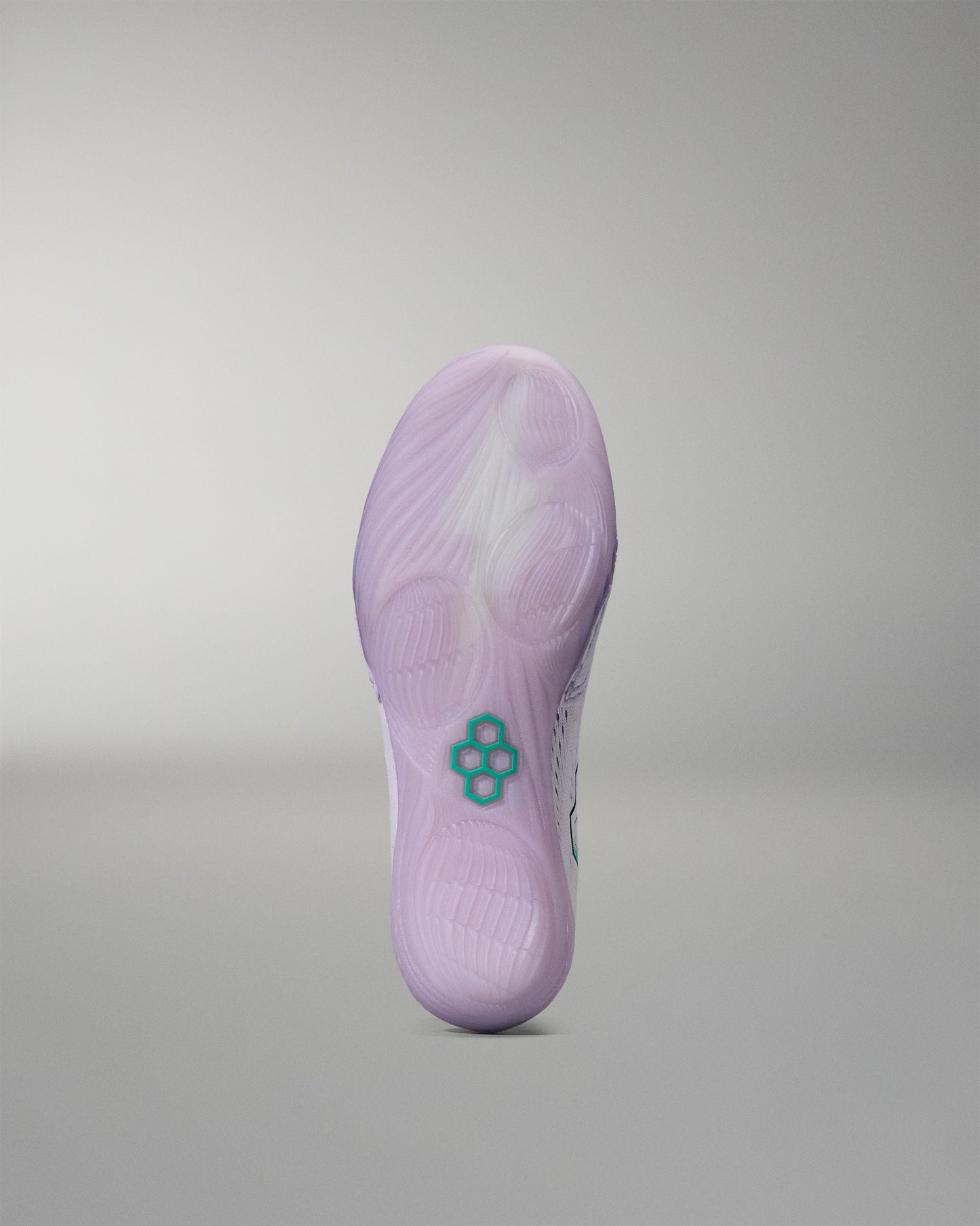 Purple sneaker sole with a brand logo on a gray background