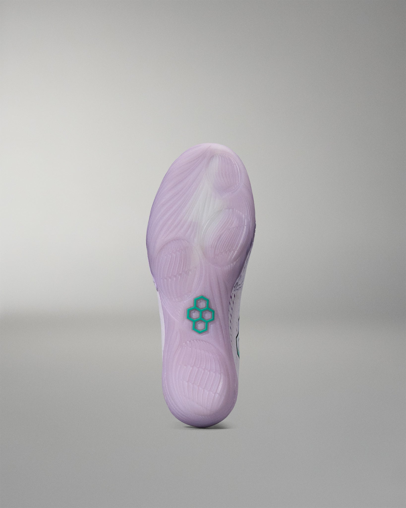 Purple sneaker sole with a brand logo on a gray background