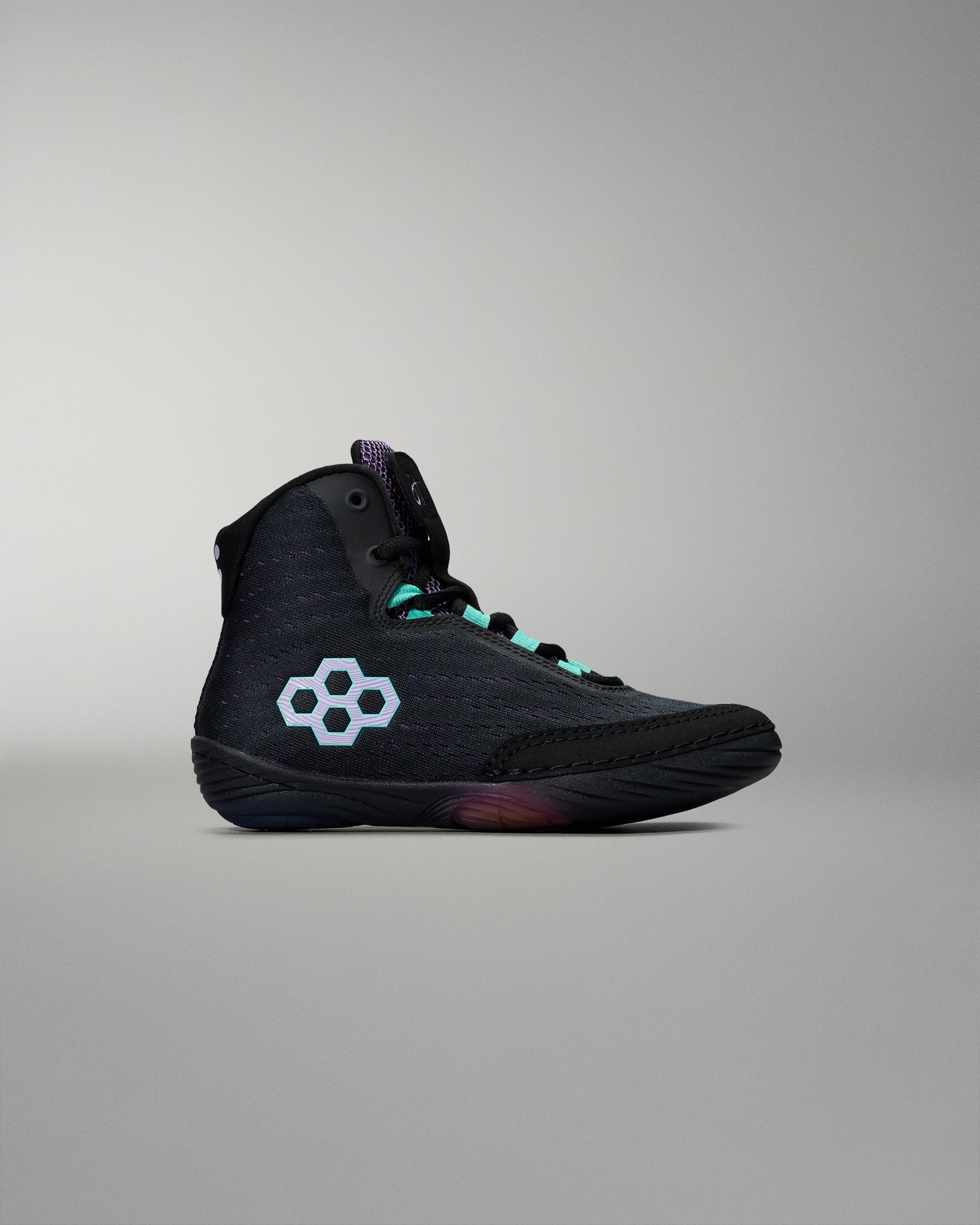 Black high-top sneaker with a white logo on a gray background
