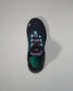 Black sneaker with purple accents on a gray background